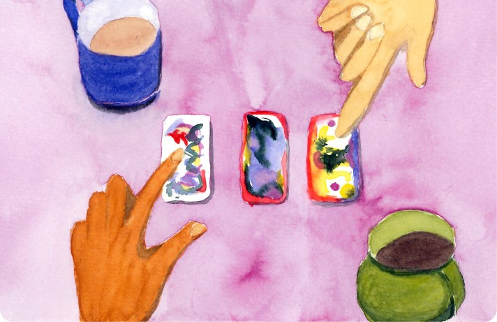 two people consider tarot and oracle cards as part of a coaching session